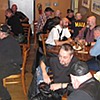 Wide shot around the corner of the dining room - as the guys are enjoying after dinner conversation